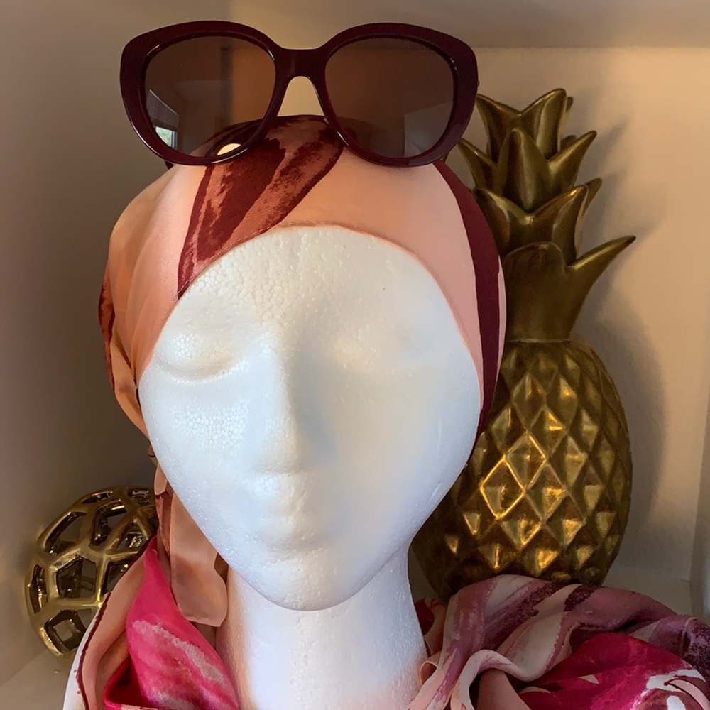 Coach sunglasses with thin rose colored arms that comes with a case
